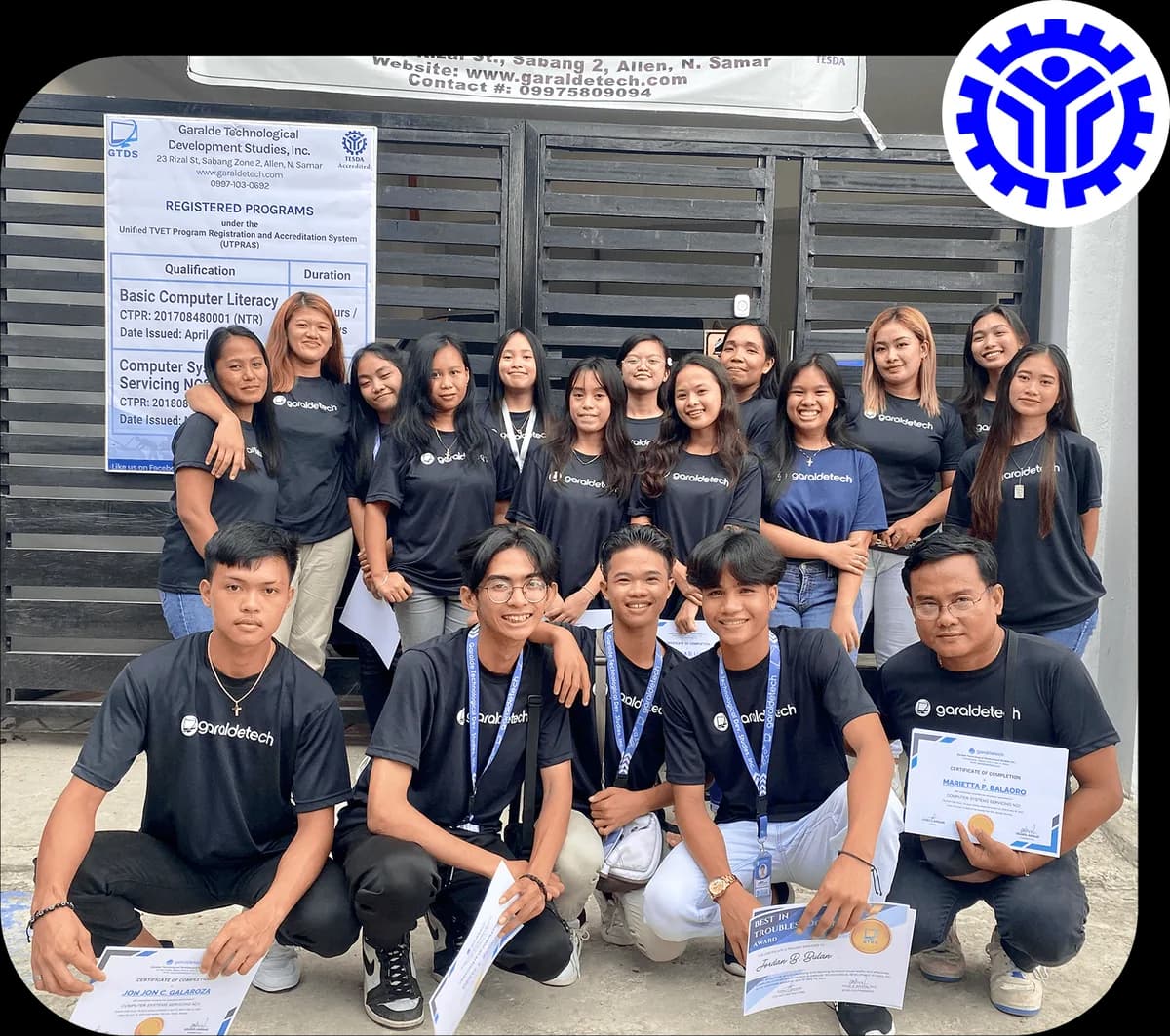 GaraldeTech trainees in GaraldeTech shirts holding their certificates outside the school in Allen